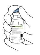 A close-up of a hand holding a bottle

Description automatically generated